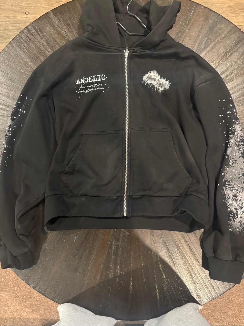 Angelic Graphic Zip-Up Hoodie in Black with White Paint Splatter